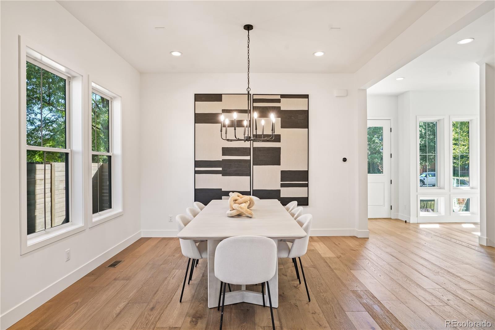 1067 South Cook Street Denver, CO 80209 - Photo 5 of 35 a view of a dining room with furniture window and wooden floor
