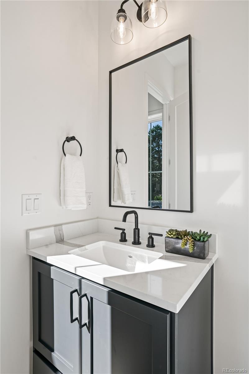 1067 South Cook Street Denver, CO 80209 - Photo 7 of 35 a bathroom with a sink and a mirror