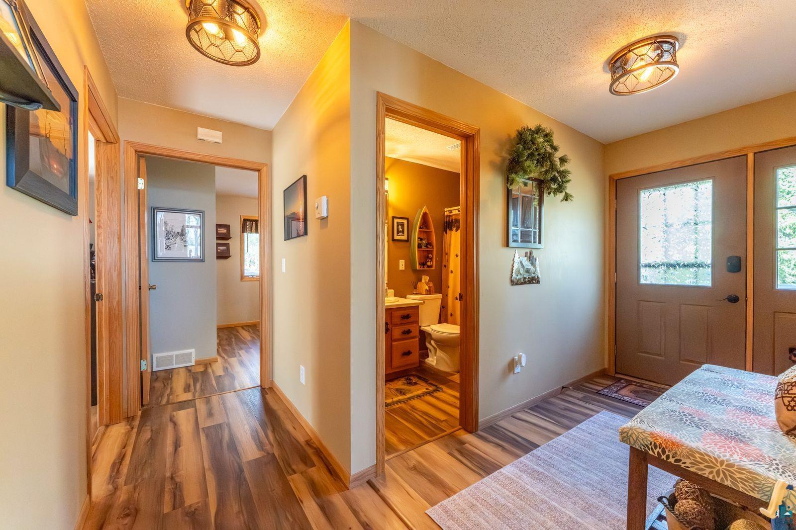4452 Moccasin Point Road Tower, MN 55790 - Photo 22 of 44 Hallway featuring wood-finish flooring, warm neutral wall tones, and recessed lighting fixtures