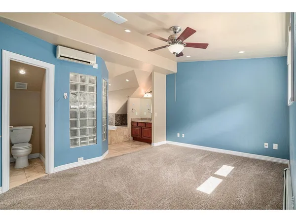a view of a livingroom with a ceiling fan and bathroom