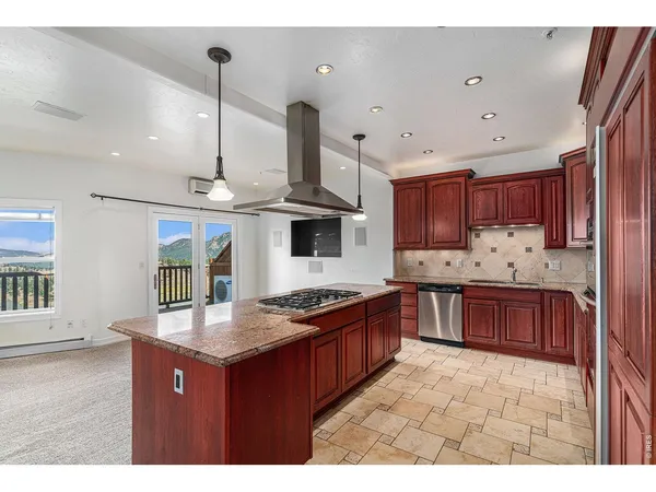 a kitchen with granite countertop a sink and a stove