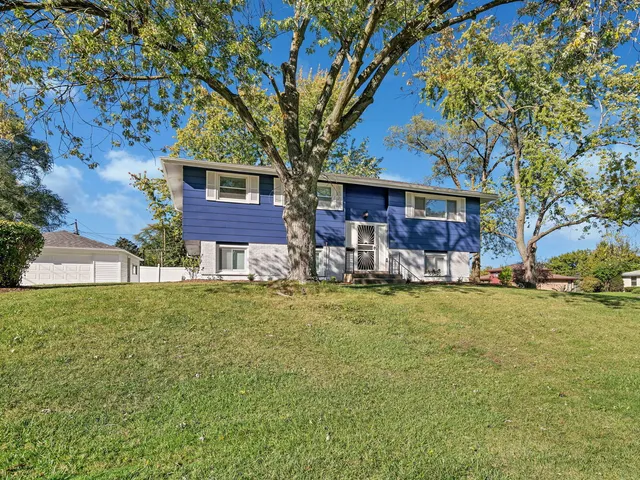 a backyard of a house with table and chairs