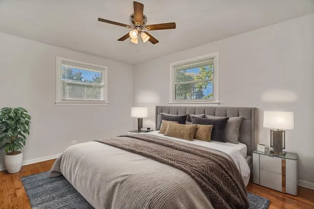 a bedroom with bed and a potted plant