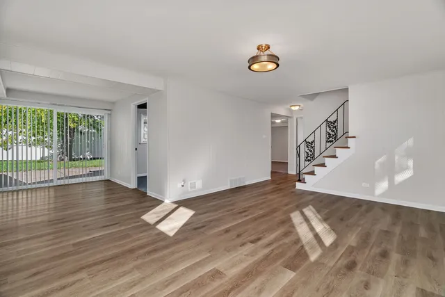 a view of an entryway with wooden floor