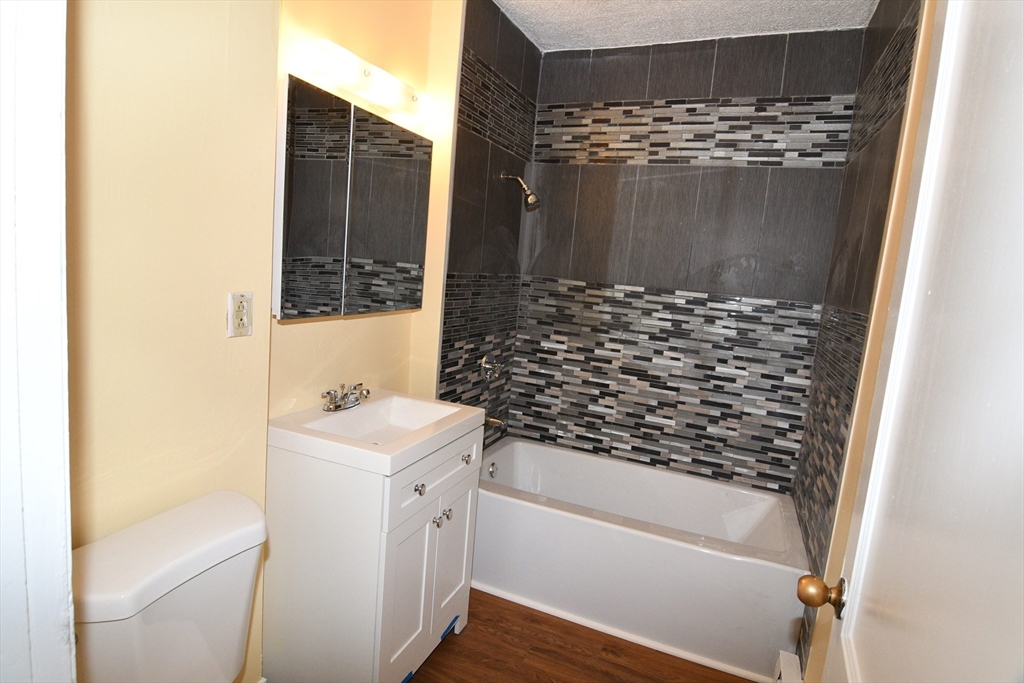 112 Johnson Street Lynn, MA 01902 - Photo 13 of 28 a bathroom with a sink a toilet and shower