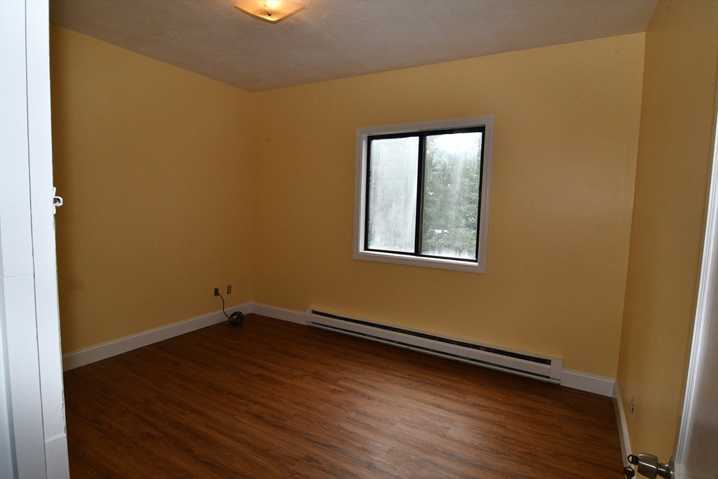 112 Johnson Street Lynn, MA 01902 - Photo 15 of 28 a view of a room with wooden floor and windows