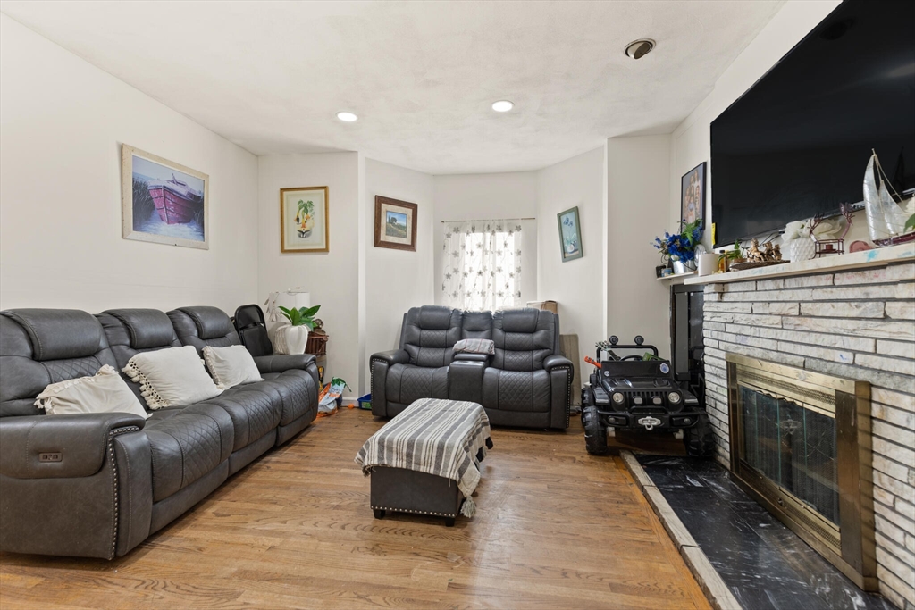 112 Johnson Street Lynn, MA 01902 - Photo 18 of 28 a living room with furniture flat screen tv and a fireplace