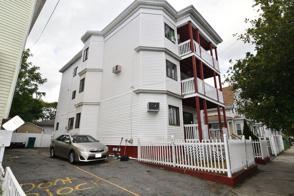 112 Johnson Street Lynn, MA 01902 - Photo 2 of 28 a car parked in front of a white house