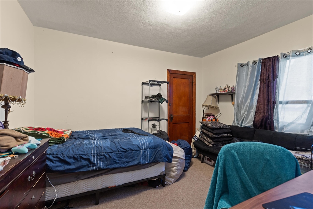 112 Johnson Street Lynn, MA 01902 - Photo 23 of 28 a bedroom with a bed and a window