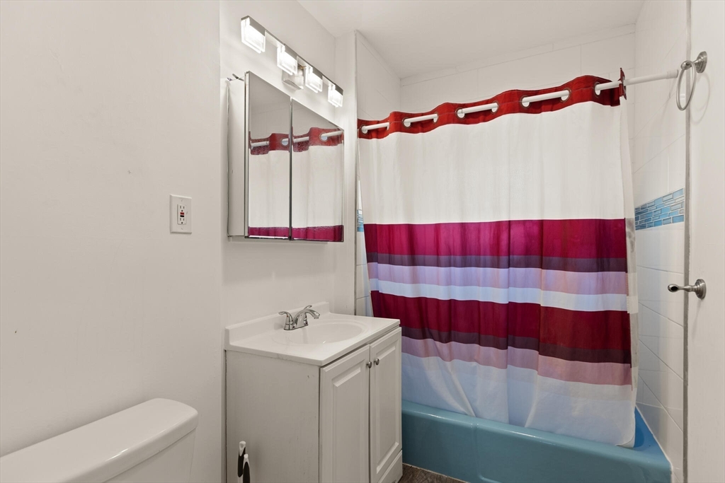 112 Johnson Street Lynn, MA 01902 - Photo 27 of 28 a bathroom with a sink and a mirror