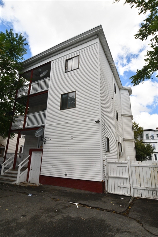 112 Johnson Street Lynn, MA 01902 - Photo 4 of 28 a front view of a house with a garage