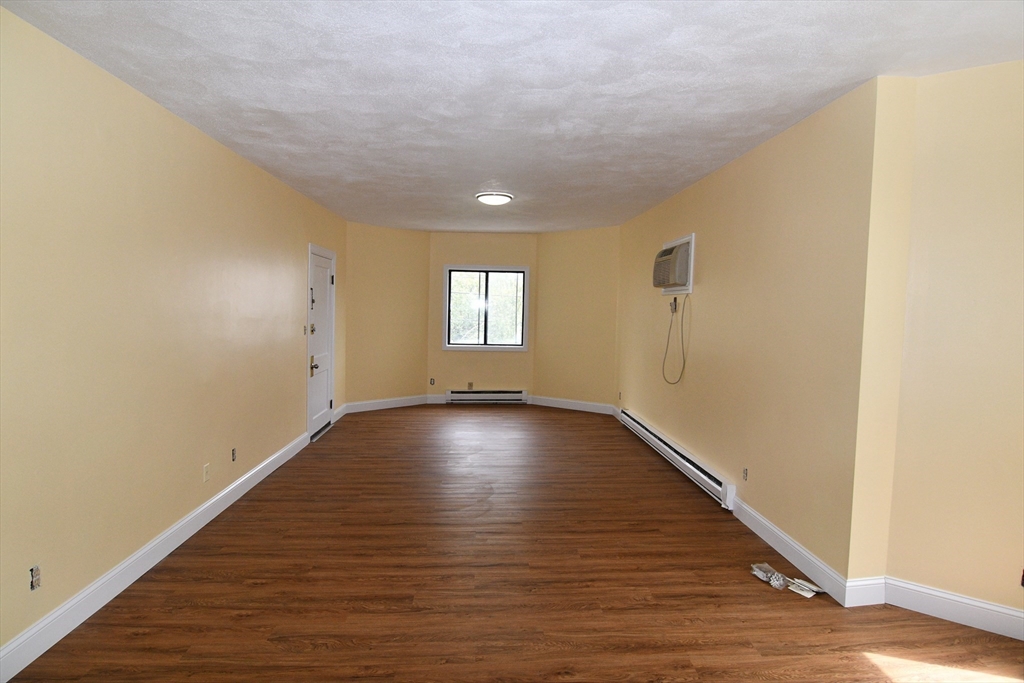 112 Johnson Street Lynn, MA 01902 - Photo 7 of 28 a view of empty room with window and wooden floor