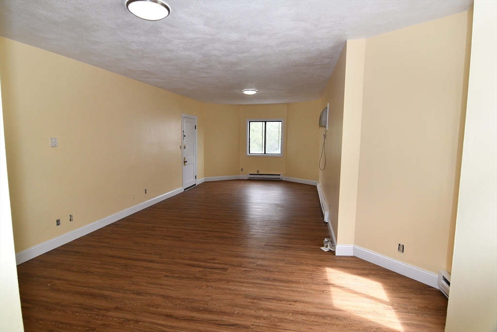 112 Johnson Street Lynn, MA 01902 - Photo 10 of 28 a view of an empty room with wooden floor