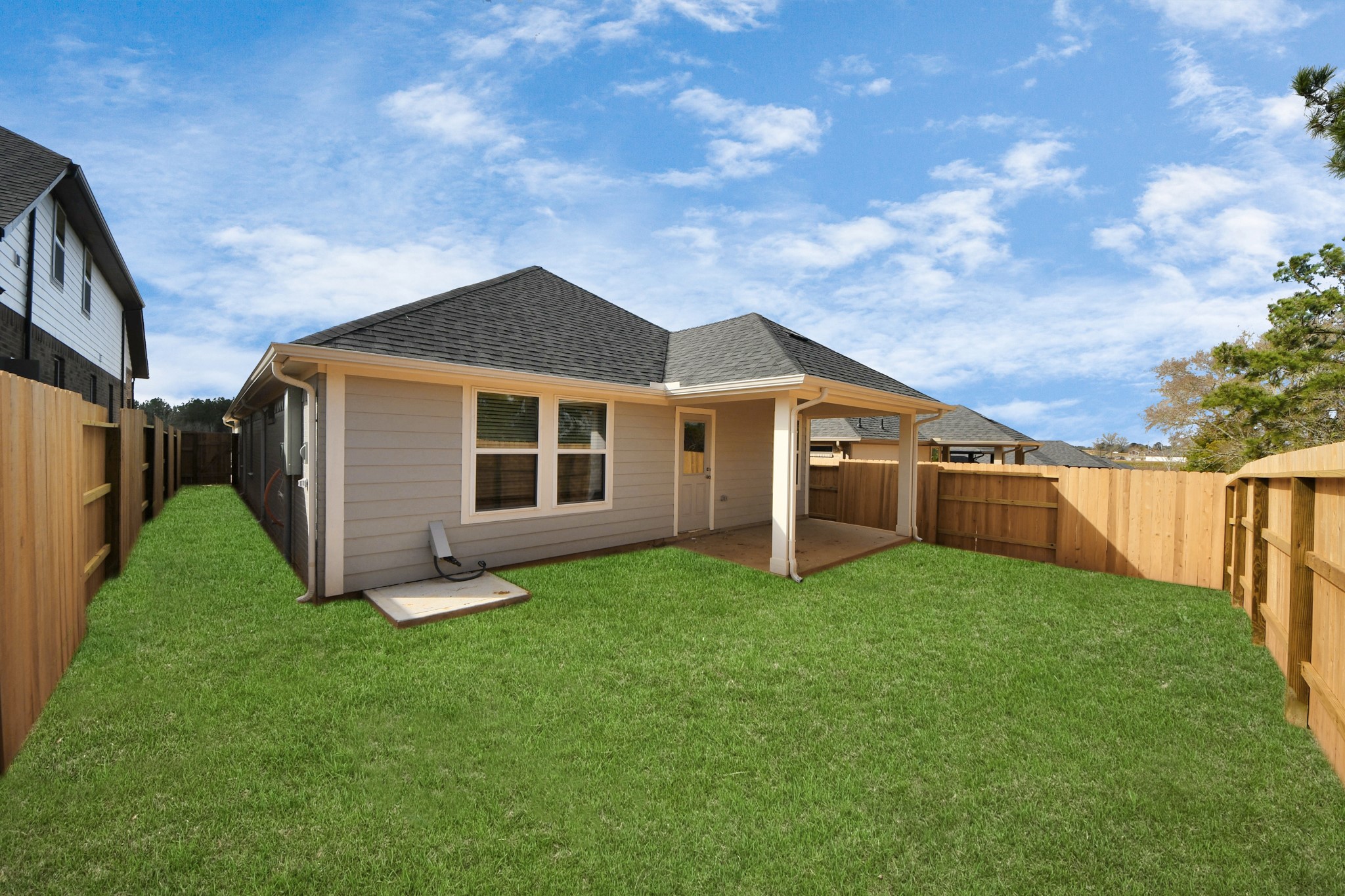 19555 Montgomery Rdg Way Montgomery, TX 77316 - Photo 5 of 21 Discover the charm of this spacious backyard featuring a delightful covered patio. With ample room for both play and relaxation, it's the perfect outdoor haven!