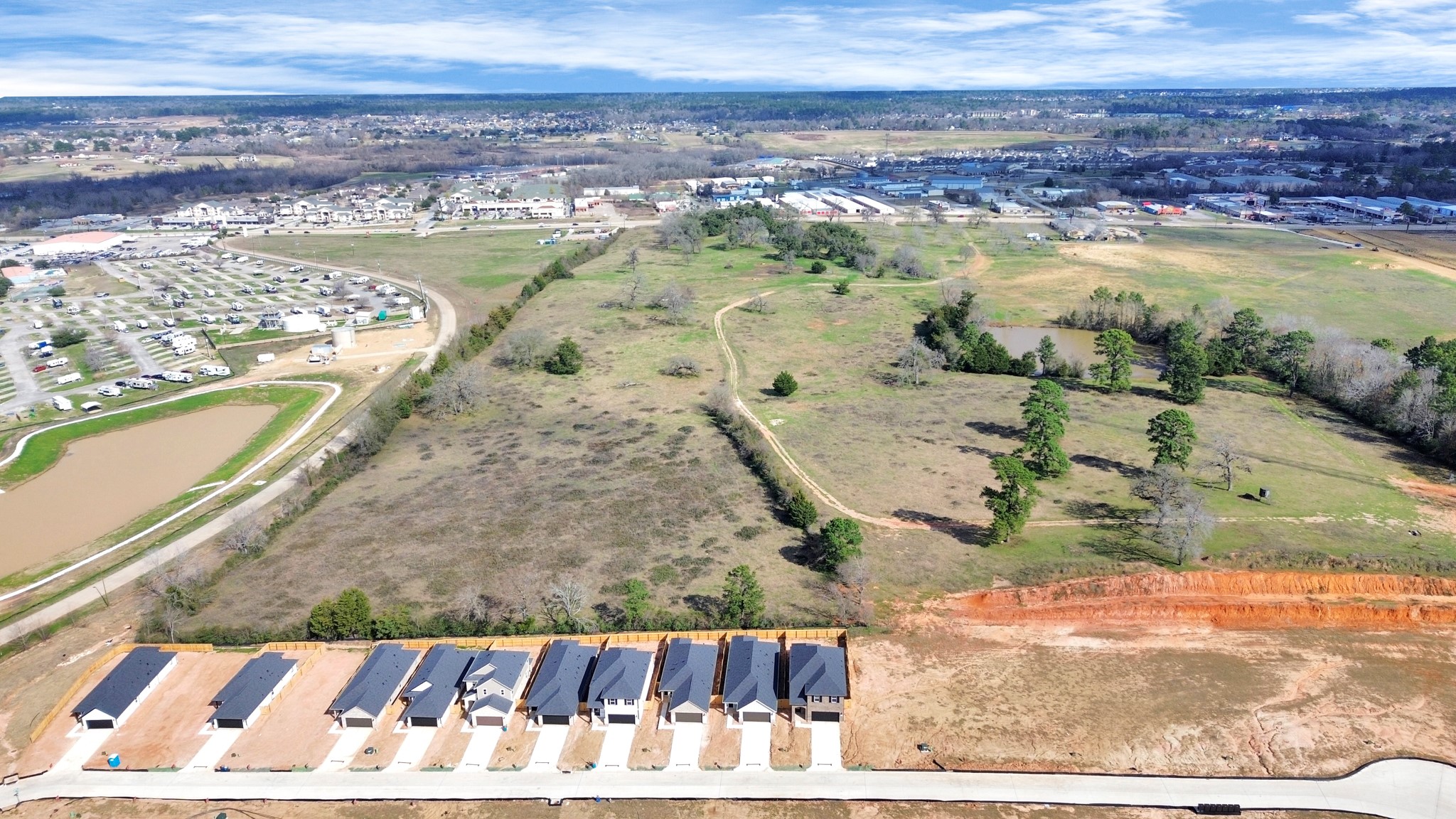 19555 Montgomery Rdg Way Montgomery, TX 77316 - Photo 7 of 21 An aerial view of a spacious subdivision lot, highlighting a well-maintained yard and a fully fenced perimeter, offering both privacy and expansive outdoor space. No back yard neighbors. Landscape pending.
