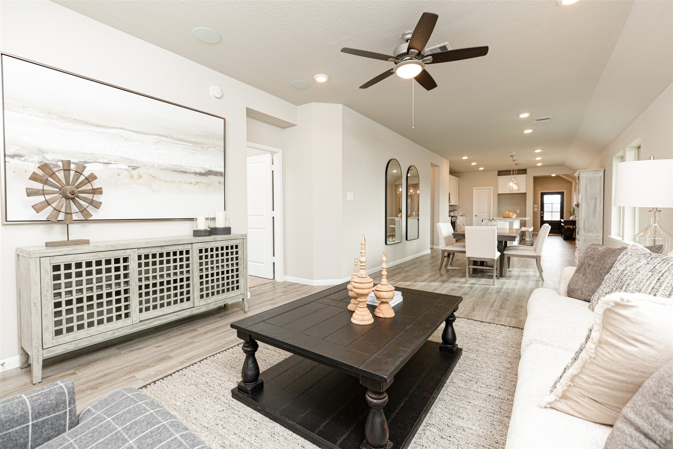 19555 Montgomery Rdg Way Montgomery, TX 77316 - Photo 16 of 21 Gather the family and guests together in your lovely living room! Featuring soaring high ceilings, recessed lighting, ceiling fan, custom paint, gorgeous floors, and large windows that provide plenty of natural lighting throughout the day. Sample photo of completed home with similar floor plan. As-built interior colors and selections may vary.