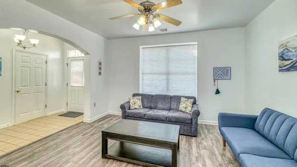 a living room with furniture and a wooden floor