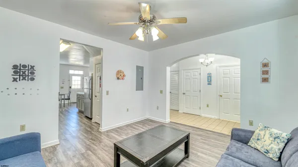 a living room with furniture and a chandelier
