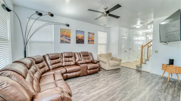 a living room with furniture and a wooden floor
