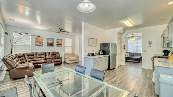 a living room with furniture and a kitchen