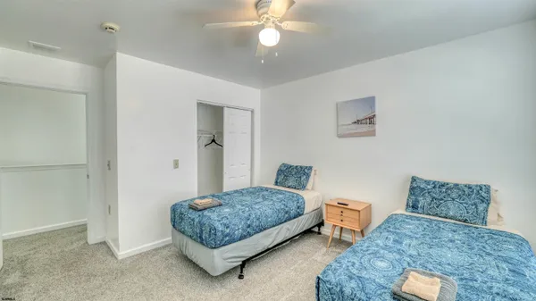 a bedroom with bed and a chandelier