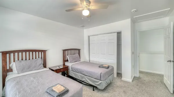 a bedroom with double bed and a chandelier