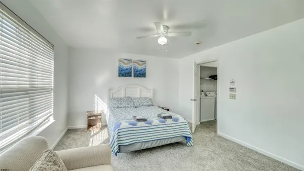 a spacious bedroom with a bed and a chandelier