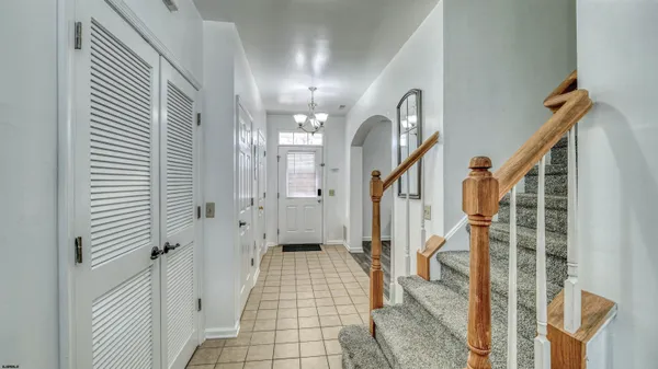 a view of a hallway with a door and stairs