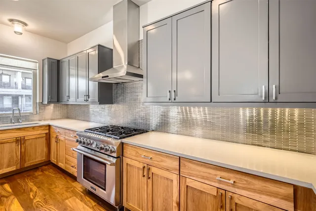 a kitchen with stainless steel appliances granite countertop a sink stove and cabinets