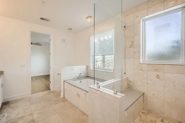 a spacious bathroom with a granite countertop sink a mirror and a