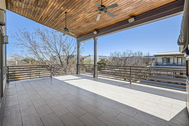 a balcony with wooden benches and a couch