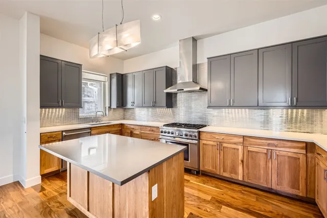 a view of a kitchen with cabinets and wooden floor