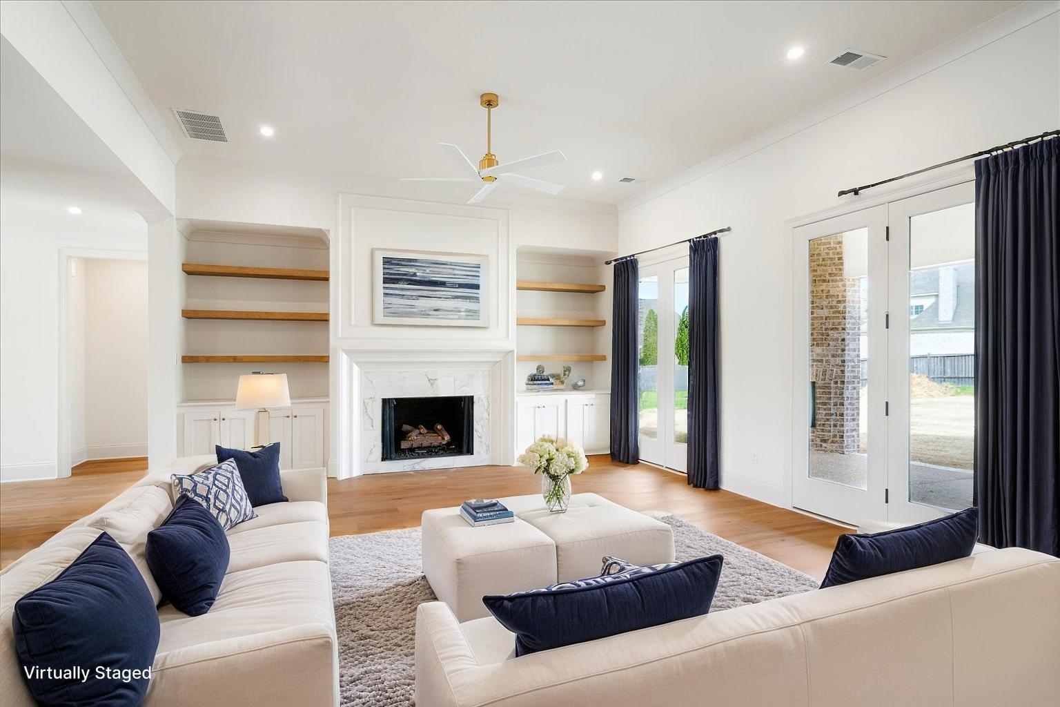 12600 Miss Cloud Road Collierville, TN 38017 - Photo 10 of 40 Living room with light wood finished floors, ceiling fan, a premium fireplace, ornamental molding, and recessed lighting
