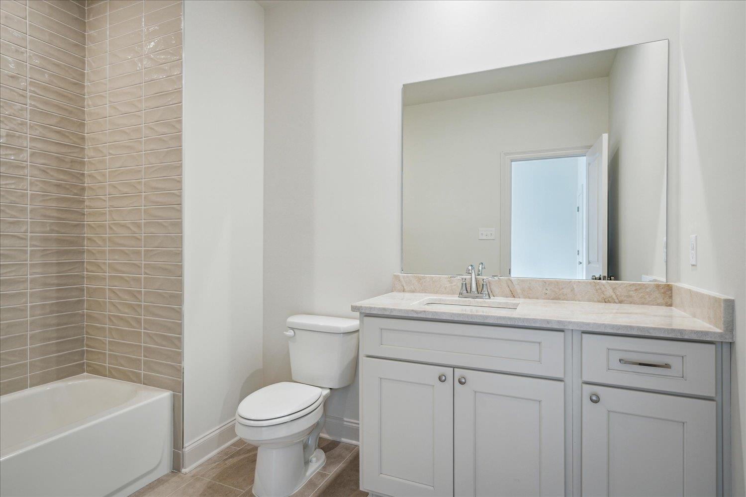 12600 Miss Cloud Road Collierville, TN 38017 - Photo 32 of 40 Bathroom featuring walk in shower, baseboards, toilet, vanity, and a tub to relax in