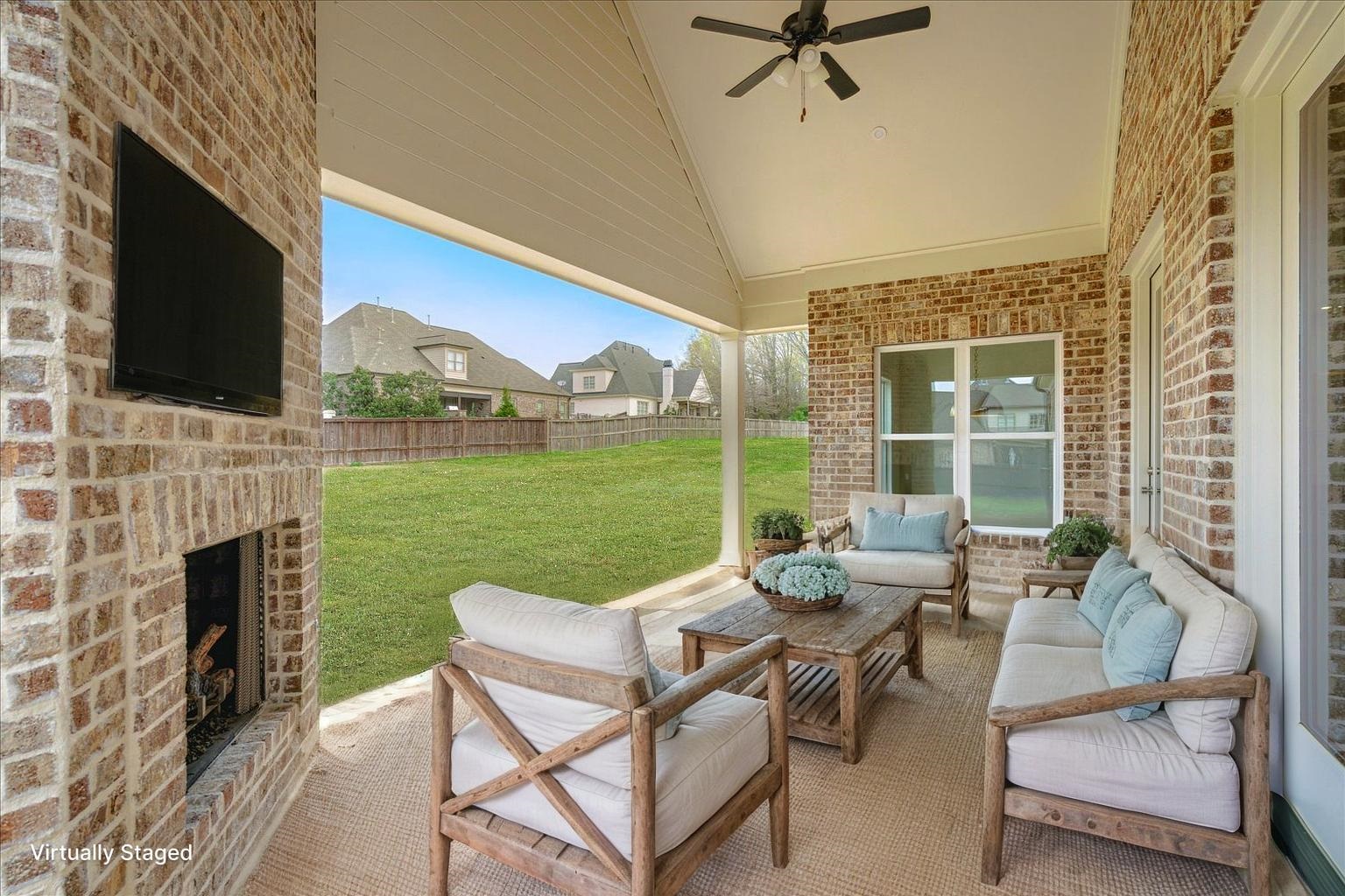 12600 Miss Cloud Road Collierville, TN 38017 - Photo 33 of 40 View of patio with an outdoor living space with a fireplace and a ceiling fan