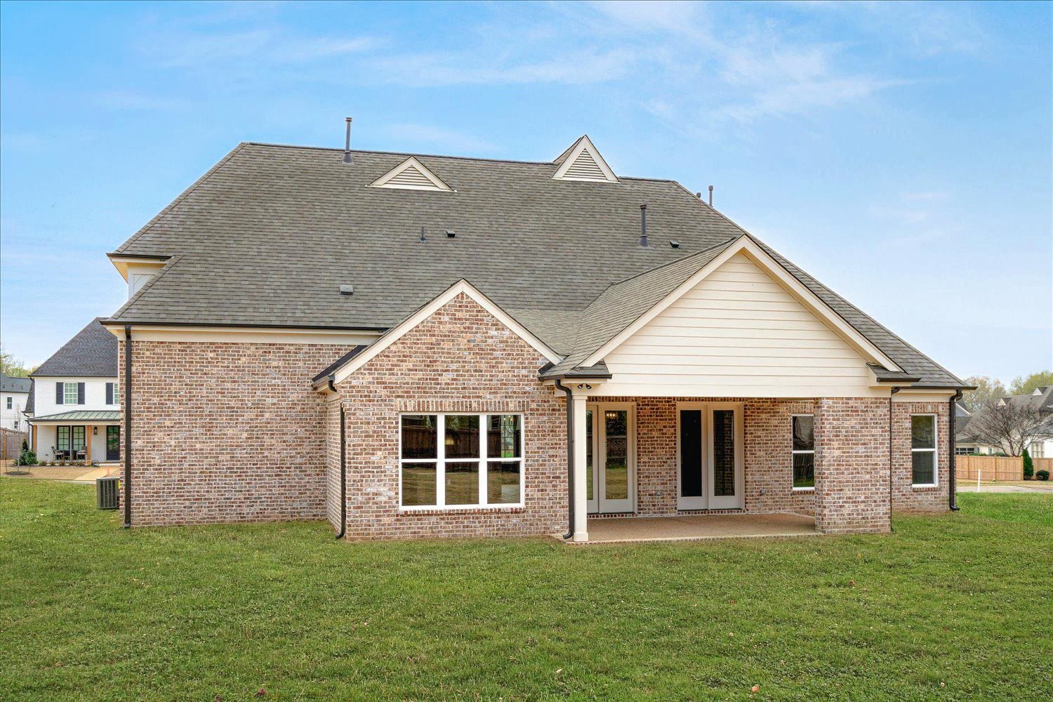 12600 Miss Cloud Road Collierville, TN 38017 - Photo 35 of 40 Rear view of property featuring brick siding, a lawn, a shingled roof, and a patio