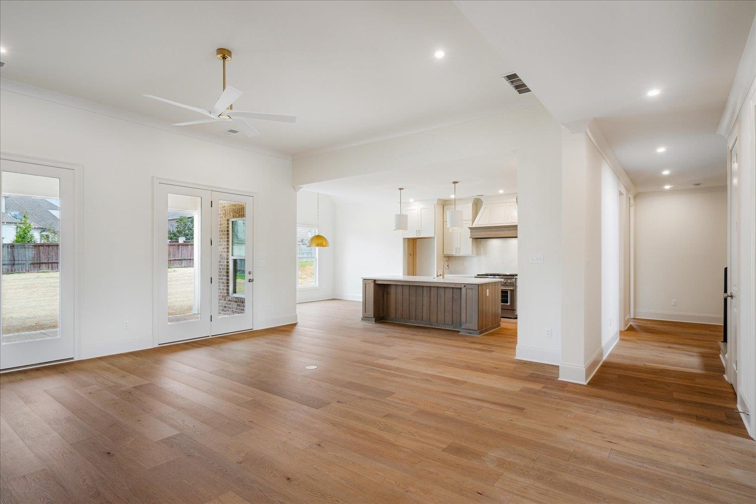 12600 Miss Cloud Road Collierville, TN 38017 - Photo 8 of 40 Unfurnished living room featuring visible vents, baseboards, ceiling fan, recessed lighting, and light wood-type flooring