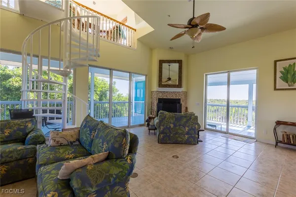 a living room with furniture a flat screen tv and a window