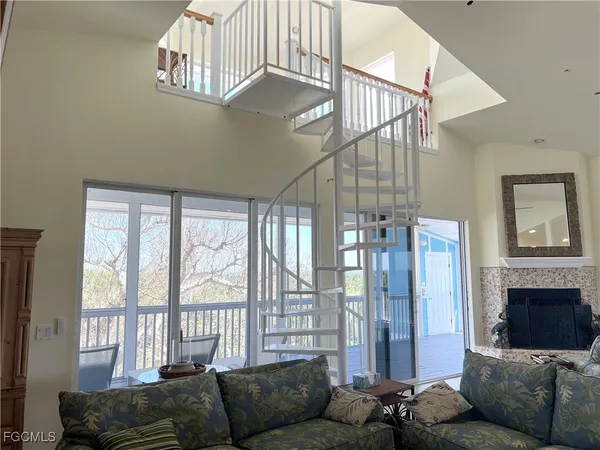 a living room with furniture and a floor to ceiling window