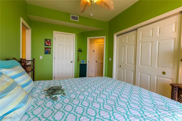 a bedroom with a bed and a chandelier