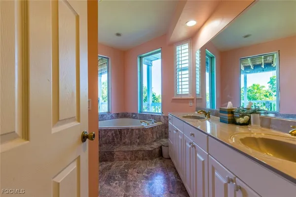 a bathroom with sink bathtub and window