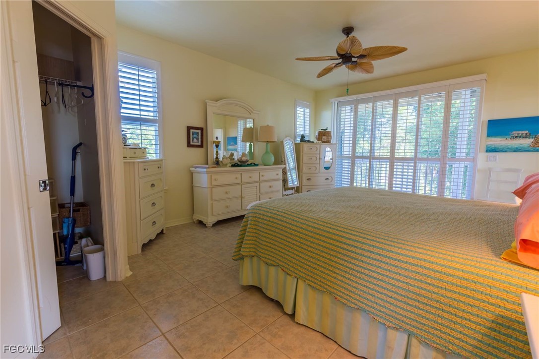 621 Rum Road Captiva, FL 33924 - Photo 25 of 50 a bedroom with a bed and a chandelier