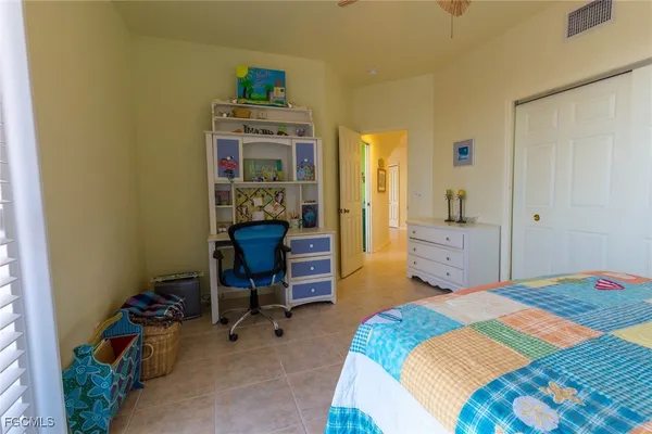 a bedroom with a bed and a desk