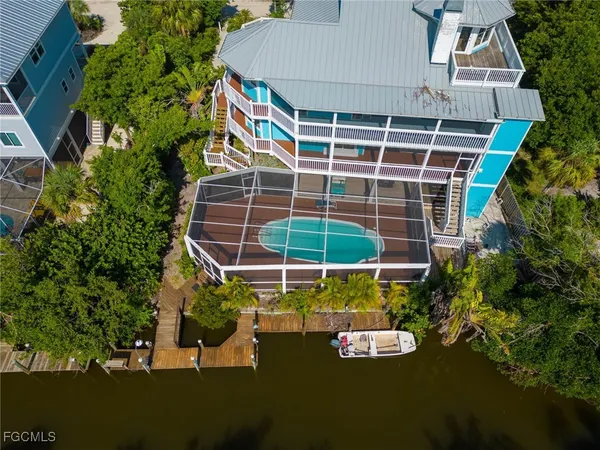 a view of a backyard with plants and a lake view