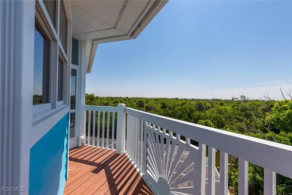 a view of a balcony with wooden floor