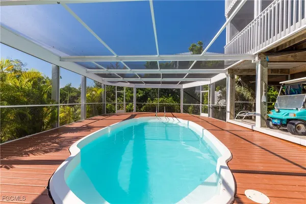 a view of a backyard with porch and a tub