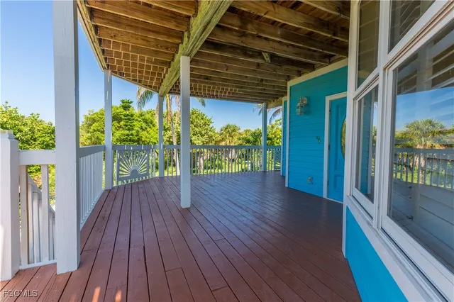 a porch with seating space and hardwood floor