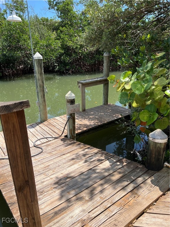 621 Rum Road Captiva, FL 33924 - Photo 46 of 50 a roof deck with table and chairs and wooden floor