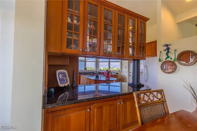 a view of a two chairs and table in a kitchen