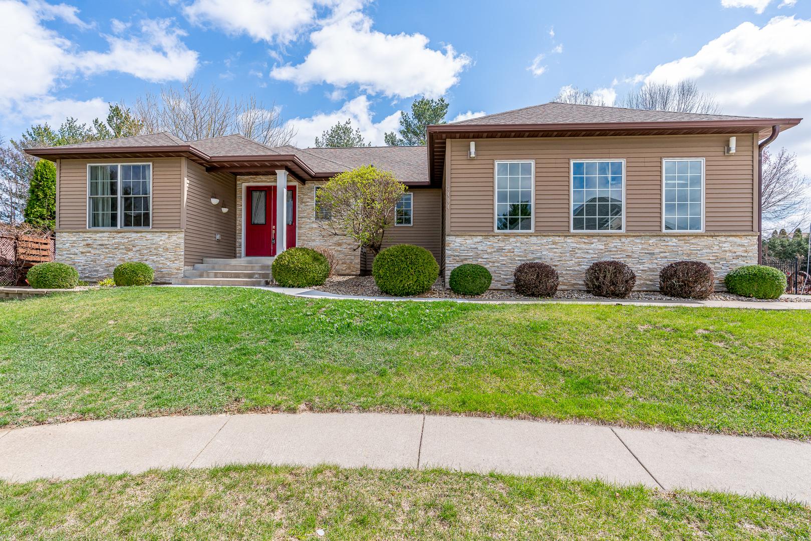 3404 77th St Court Moline, IL 61265 - Photo 1 of 37 a front view of a house with a garden and yard